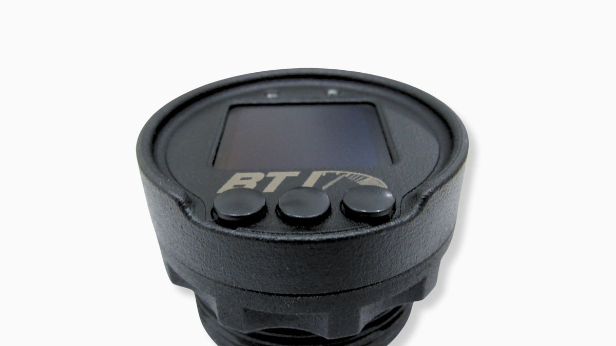 Angled view of the BTI 52mm OLED CAN gauge showing the textured housing, three buttons and shift light LEDs, Tuned By Shawn